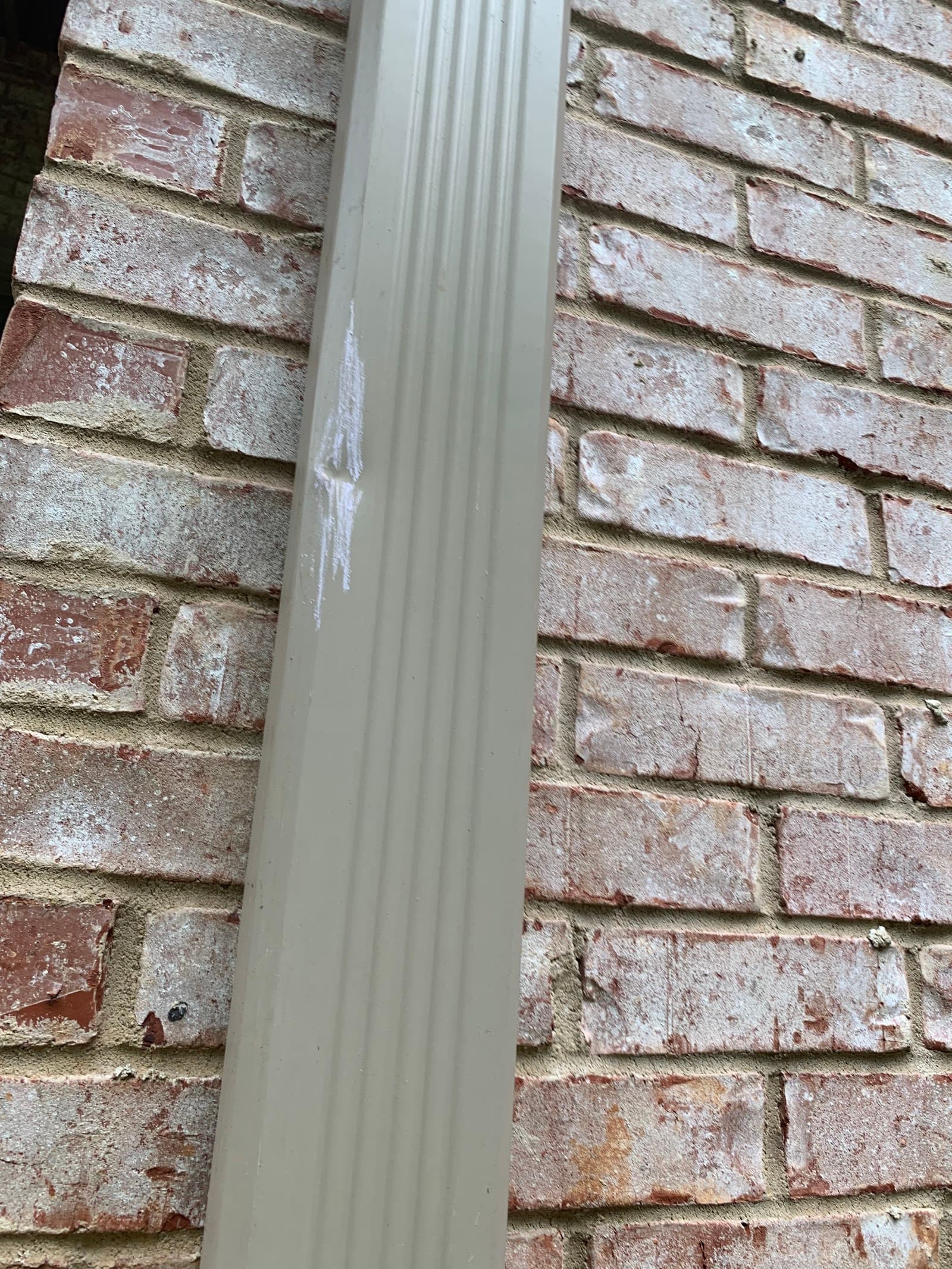Hail impact damage visible on the siding of a North Georgia home