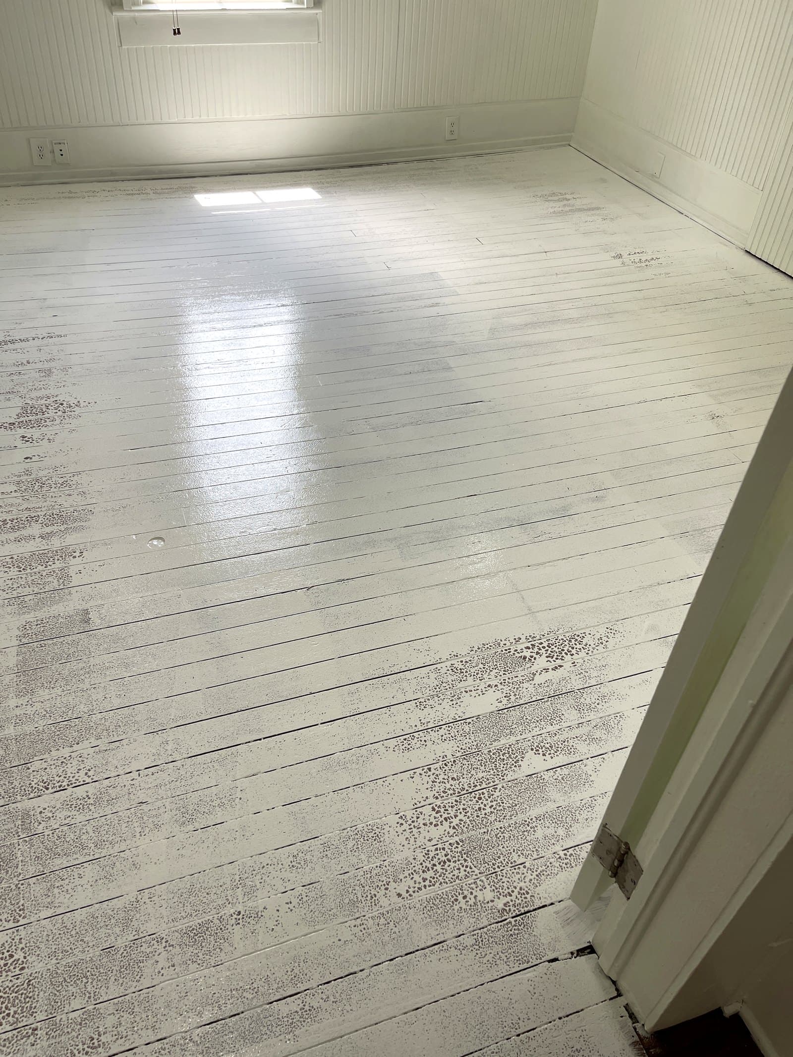 Water staining spreading across an interior ceiling below a roof leak