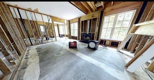 Air movers and drying equipment running during a structural dry-out after water damage