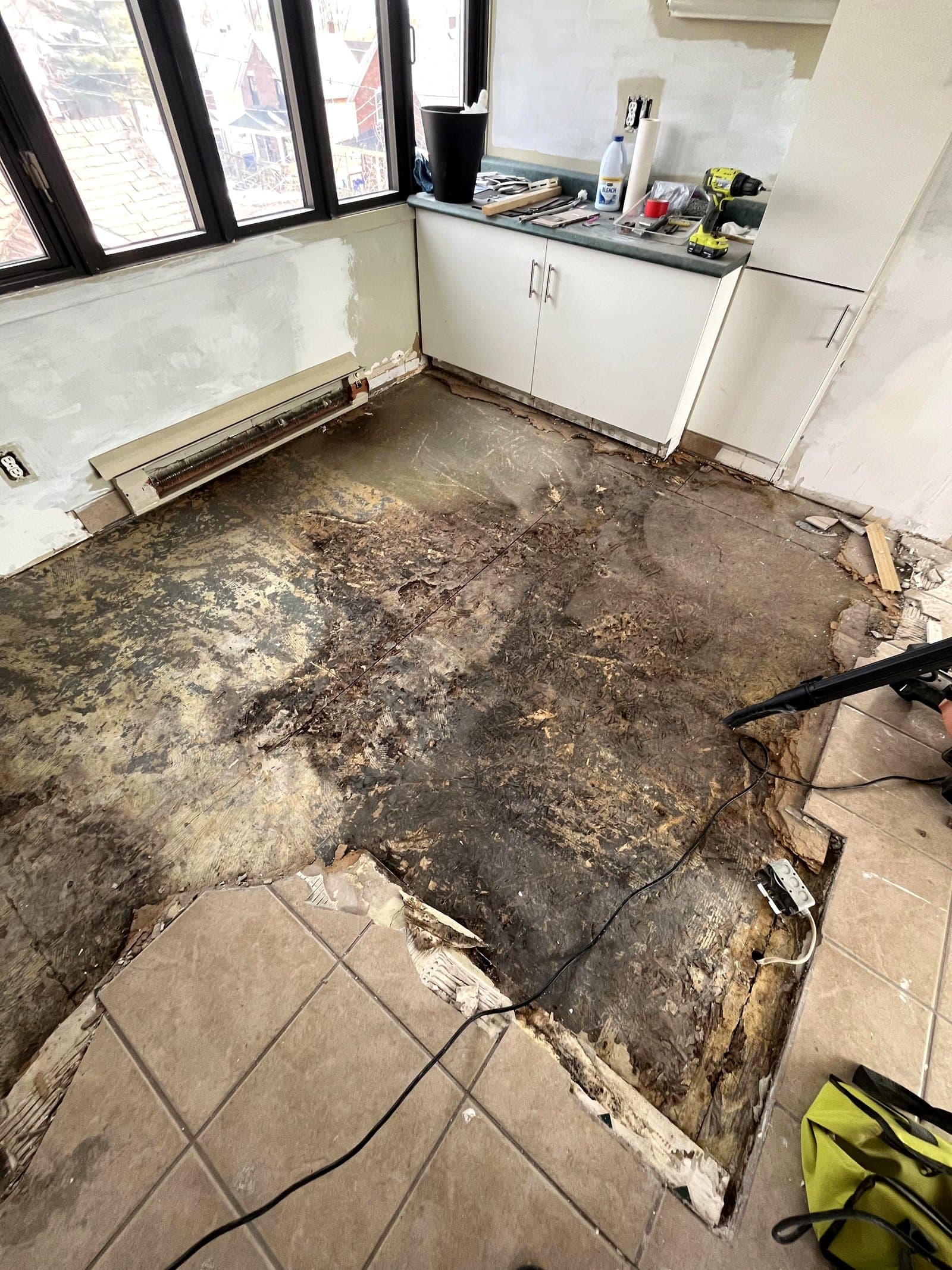 Flooring removed down to the subfloor with drying equipment running during water mitigation