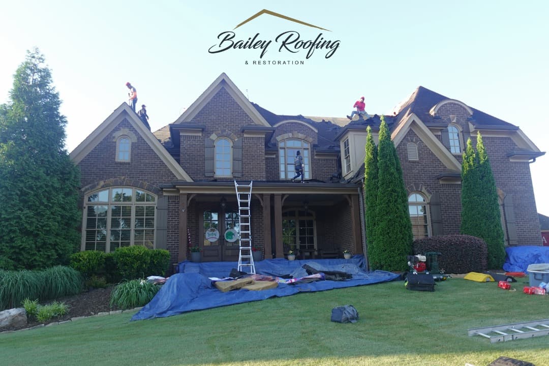 A Bailey crew working on a brick home's roof